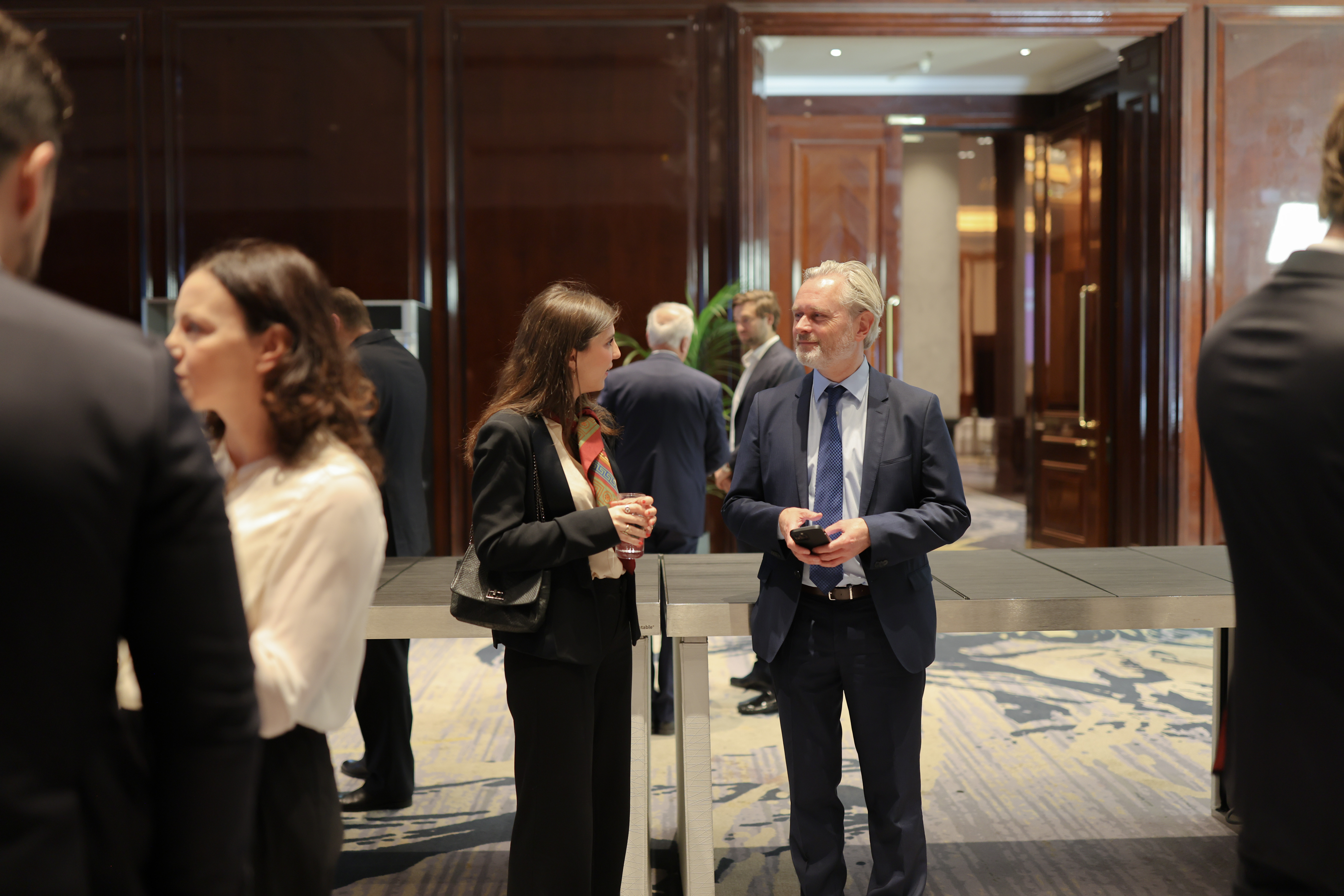 Guests in conversation between sessions at the International Wealth Forum 2025